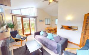 a living room with a purple couch and chairs at CROYDE DUNE LODGE 3 Bedrooms in Croyde