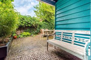 a wooden bench sitting next to a blue wall at Ocho in Zandvoort