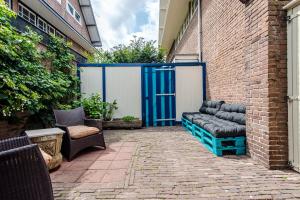 a patio with two chairs and a blue door at Ocho in Zandvoort