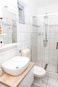 une salle de bain blanche avec un lavabo et des toilettes dans l'établissement Marika Vendégháza, à Tokaj