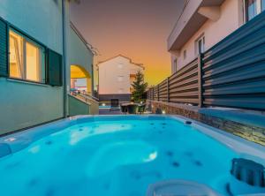 a hot tub on the balcony of a building at Villa S in Vodice