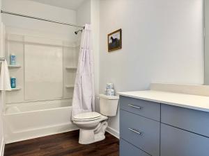 a white bathroom with a toilet and a shower at Luxury 1B1B with Balcony Downtown 542Blvd in Atlanta