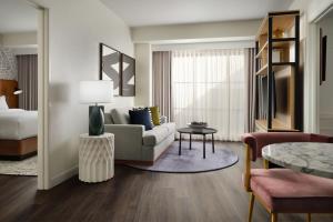 a living room with a couch and a table at Burton House, Beverly Hills, A Tribute Portfolio Hotel in Los Angeles