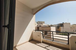 a balcony with a view of a city at Spacious 2 bedroom apartment in Cospicua