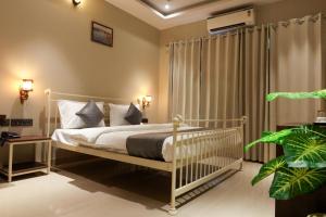 a bedroom with a white crib in a room at Jaipur Qila - A Boutique Hotel and Rooftop Cafe in Jaipur