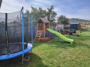 einen Spielplatz mit Rutsche und Schaukel in der Unterkunft Furmint Home in Szegi
