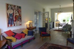 a living room with a couch with colorful pillows at Family Home Marie in Zandvoort