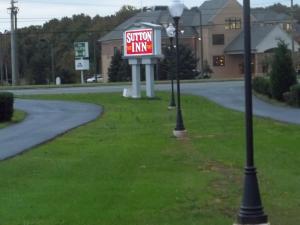 a sign for a southern inn on the side of a road at Sutton Inn in Elkton
