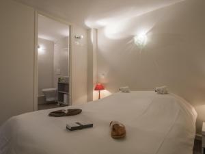 a bedroom with a white bed with shoes on it at Triplex moderne avec terrasse à Courchevel 1850, près des pistes et services, 3 suites, parking - FR-1-575-145 in Courchevel