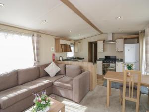 a living room and kitchen with a couch and a table at Hazel in Denny