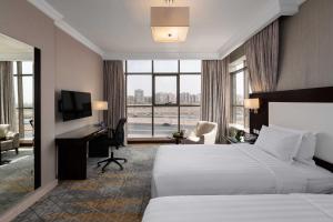 una camera d'albergo con un letto e una scrivania di Warwick Hotel Jeddah a Gedda