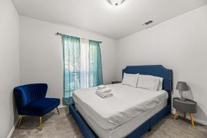 a bedroom with a blue bed and a blue chair at Spacious Single-Story Plano Home in Plano