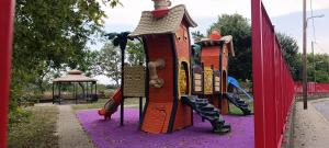 a playground with a slide in a park at Park Apartment in Xanthi