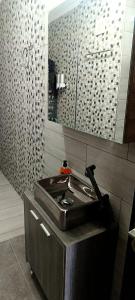 a bathroom with a sink and a mirror at Park Apartment in Xanthi +22 photos