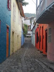 an alley in an old town with colorful buildings at @habitacionhonda in Honda