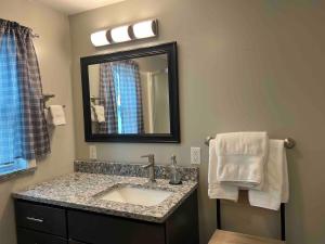 a bathroom with a sink and a mirror at Apt A The Yellow Shuttered House in Sharon +14 photos