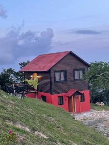 a house on top of a grassy hill at Luz de luna in La Cumbre