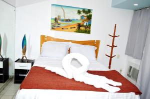 a bedroom with a bed with a swan decoration on it at Costeira Praia 103 in Natal +23 photos