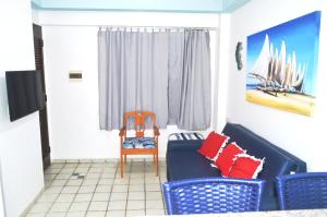 a living room with two chairs and a couch at Costeira Praia 103 in Natal