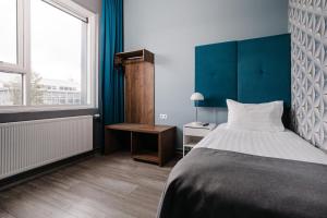 Letto o letti in una camera di ODDSSON Midtown Hotel
