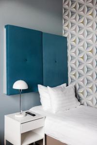 Letto o letti in una camera di ODDSSON Midtown Hotel