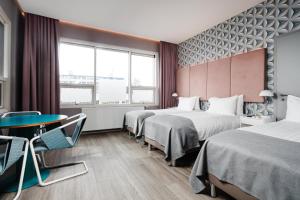 Postel nebo postele na pokoji v ubytování ODDSSON Midtown Hotel + 37 fotografií