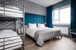 Letto o letti in una camera di ODDSSON Midtown Hotel