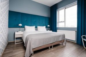 Letto o letti in una camera di ODDSSON Midtown Hotel