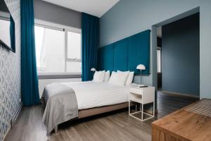 Letto o letti in una camera di ODDSSON Midtown Hotel