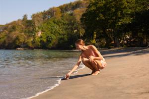a woman on a beach playing with a frisbee at Sheraton Senggigi Beach Resort in Senggigi