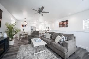 a living room with a couch and a table at Sleeps 22 Two Houses Game Rooms in Oceano