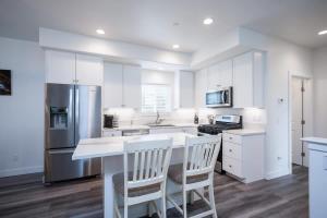 a kitchen with white cabinets and a white counter top at Game Room! Rooftop Deck! Sleeps 11 in Oceano