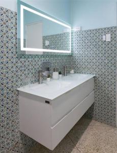 a bathroom with a white sink and a mirror at Hacienda Cumbre Bella in Ciales +95 photos