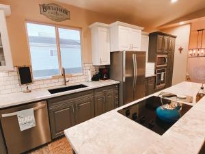 a kitchen with stainless steel appliances and a window at Coastal Retreat - Just Steps to the Beach in Oceano +24 photos