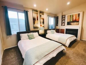 a bedroom with two beds and a fireplace at Coastal Retreat - Just Steps to the Beach in Oceano