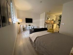a bedroom with a bed and a living room at MAMI Apto 3 in San Sebastián de la Gomera