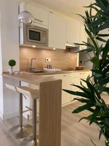 a kitchen with a counter with a sink and a microwave at MAMI Apto 3 in San Sebastián de la Gomera
