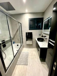 a bathroom with a shower and a sink at Maison Jacuzzi in Thonon-les-Bains +24 photos