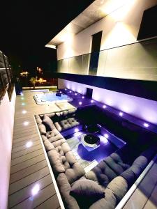 a living room with a couch and a pool at night at Maison Jacuzzi in Thonon-les-Bains