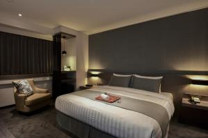 Tempat tidur dalam kamar di Wonstar Hotel