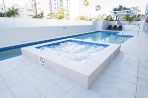 a hot tub in a pool on top of a building at Verve on Cotton Tree in Maroochydore