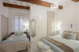 a bedroom with two beds and a mirror at Elegante Appartamento a 2 passi dal Duomo in Florence