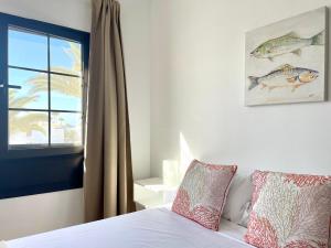 een slaapkamer met een bed en een raam bij Encanto del mar, shared pool in Puerto del Carmen +11 foto's