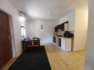 a kitchen and dining room with a table and a kitchen and a table and chairs at Dráva Fishing Apartman in Drávakeresztúr
