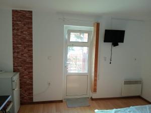 an empty room with a door and a window at Casa Hermina in Sovata