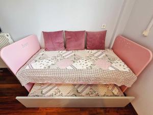 a pink bed with pink pillows in a room at Lake View in Ioannina +24 photos
