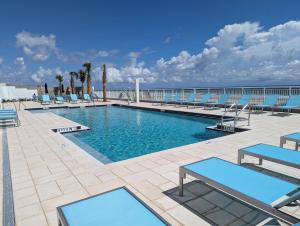 a swimming pool on the roof of a hotel at Holiday Inn Express & Suites Oceanfront Daytona Beach Shores by IHG in Daytona Beach