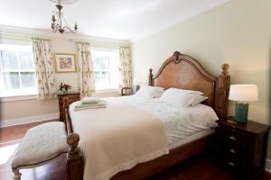 a bedroom with a large bed with a wooden headboard at Barmeath Castle Guest House in Dún Léire