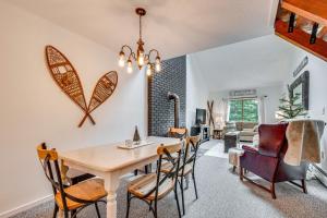 a dining room and living room with a table and chairs at Bartlett Condo 1 Mi to Attitash Mountain Resort! in Bartlett