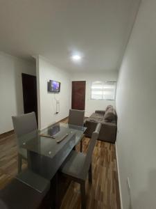 a living room with a table and a couch at Casa com Piscina individual in Paulista